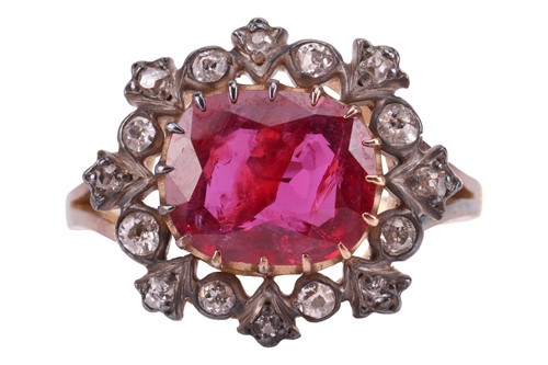 Lot 247 - A ruby and diamond cluster ring, centred with...