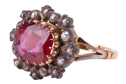 Lot 247 - A ruby and diamond cluster ring, centred with...