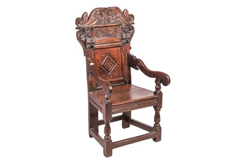 Lot A Charles II oak wainscot armchair with scroll-...