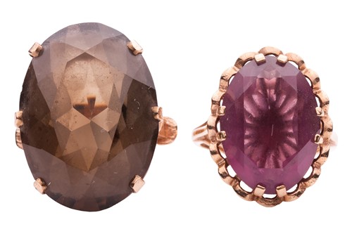 Lot 1 - A smokey quartz ring and a purple paste ring;...