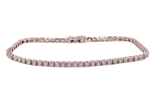 Lot A diamond-set line bracelet, comprising of...