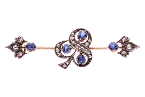 Lot A gem-set bar brooch, the trefoil motif set to...