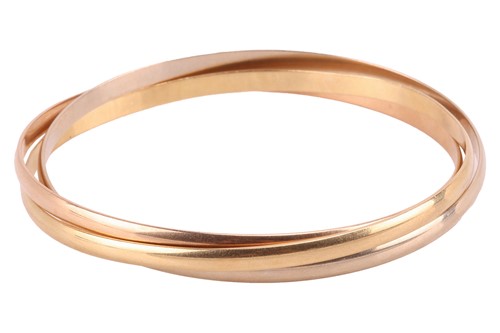 Lot Cartier – A trinity bangle in 18ct gold,...