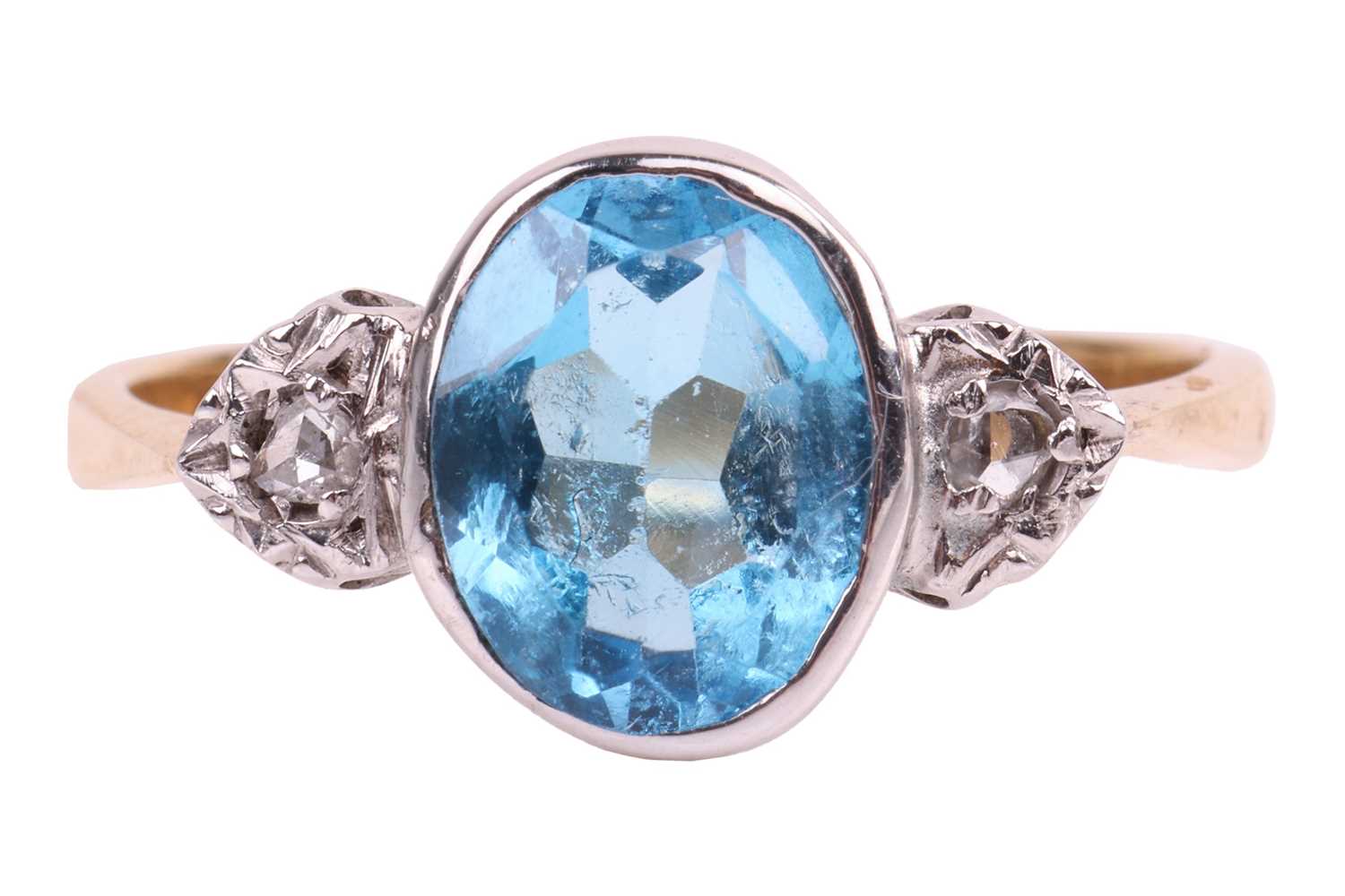 Lot 134 - A blue topaz and diamond ring, bezel-set with...