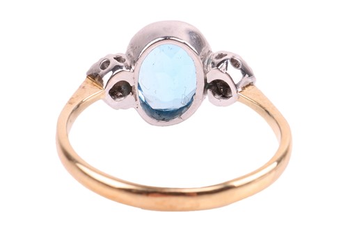 Lot 134 - A blue topaz and diamond ring, bezel-set with...