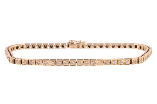 Lot 46 - A diamond line bracelet in 18ct yellow gold,...