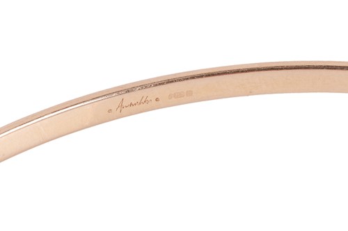 Lot 94 - A diamond-set hinged bangle in 18ct gold, of...