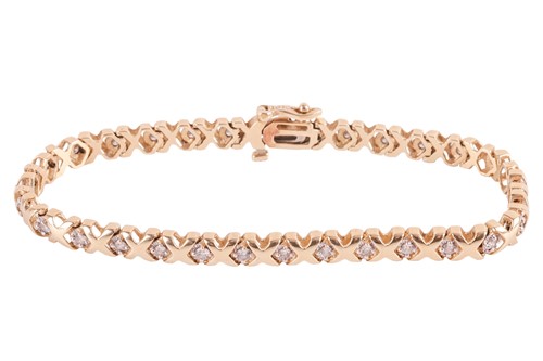 Lot 41 - A diamond-set line bracelet, with an estimated...