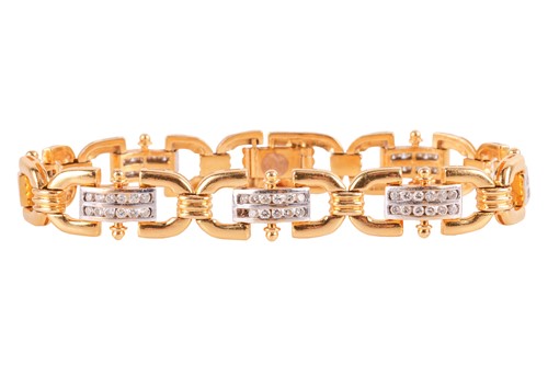 Lot 21 - A diamond-set link bracelet, of reeded design,...