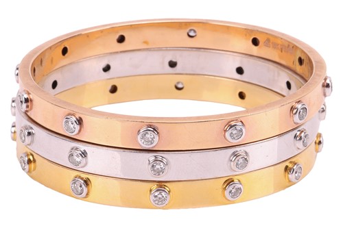 Lot 79 - A set of three diamond-set bangles, each...