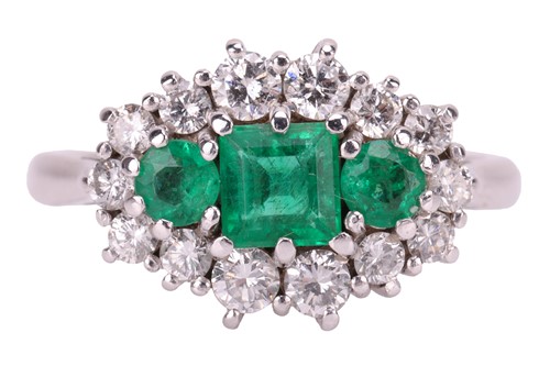 Lot 45 - An emerald and diamond cluster ring in 18ct...