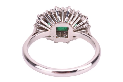 Lot 45 - An emerald and diamond cluster ring in 18ct...