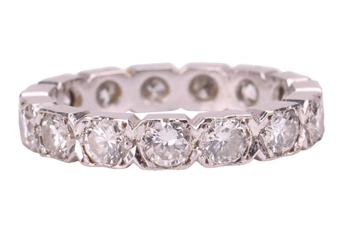 Lot 78 - A diamond eternity ring in platinum, with an...