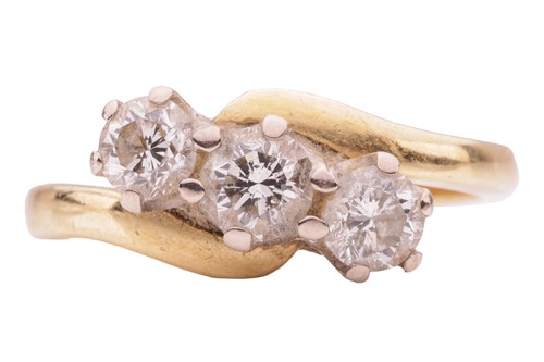 Lot 28 - A three-stone diamond crossover ring,...