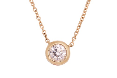 Lot 183 - A solitaire diamond necklace, featuring a...