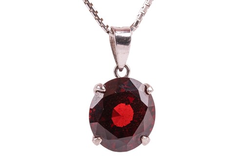 Lot 62 - A garnet pendant on chain, the oval mixed-cut...