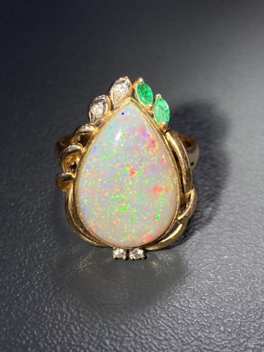 Lot 64 - An opal dress ring, collet-set with a...