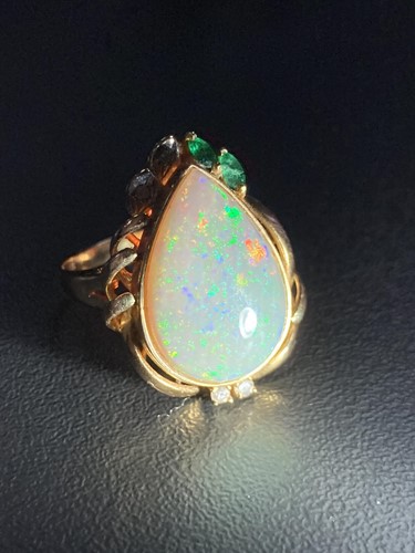 Lot 64 - An opal dress ring, collet-set with a...