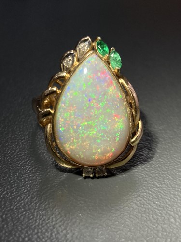 Lot 64 - An opal dress ring, collet-set with a...
