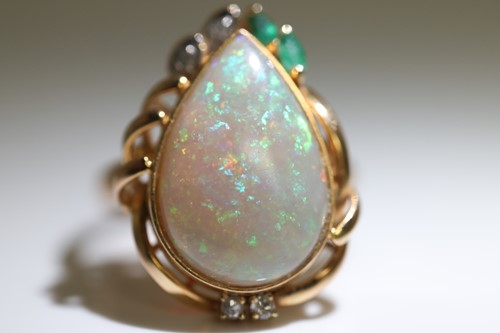 Lot 64 - An opal dress ring, collet-set with a...
