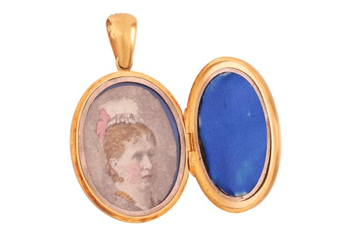 Lot 7 - A locket pendant of oval form, cover adorned...