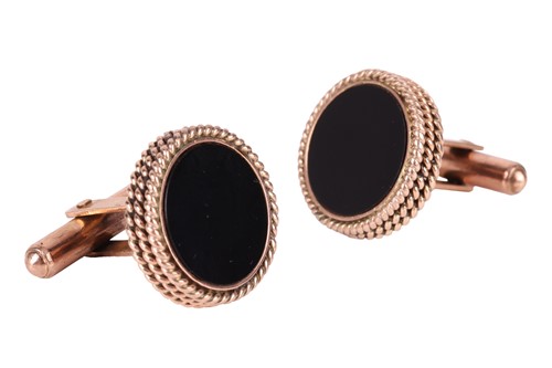 Lot 33 - A pair of onyx-set cufflinks, each containing...