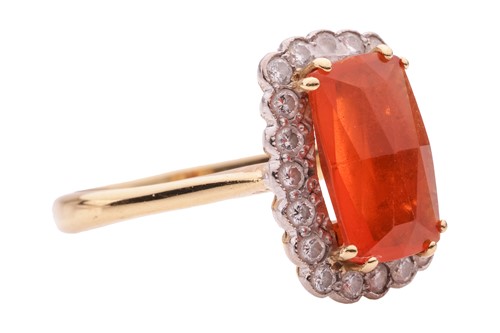 Lot 4 - A fire opal and diamond halo ring in 18ct gold,...