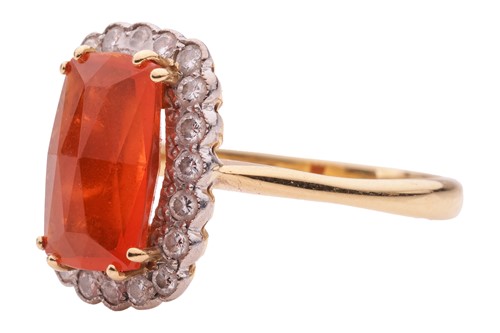 Lot 4 - A fire opal and diamond halo ring in 18ct gold,...