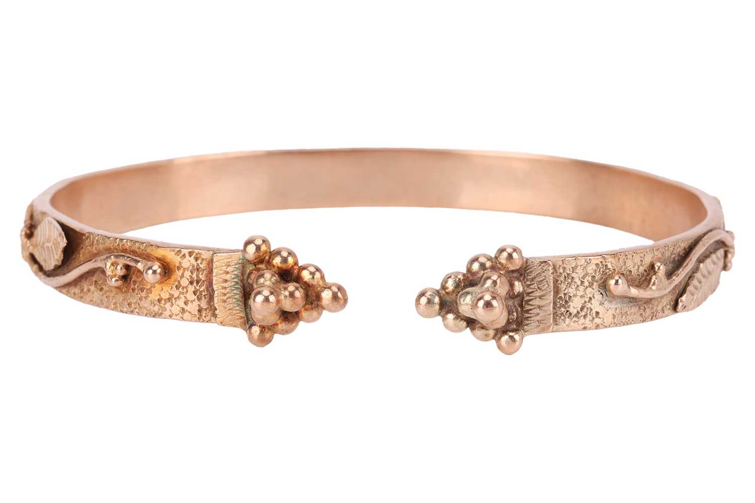 Lot 125 - A bangle of foliate design; an open bangle,