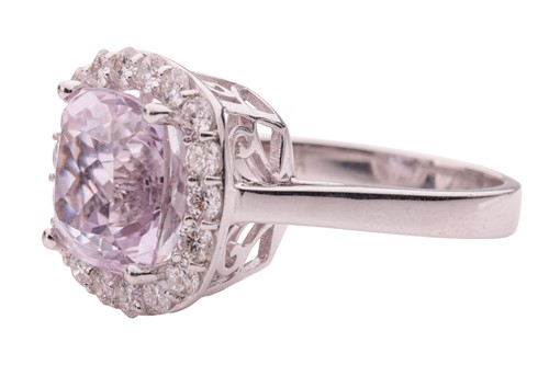 Lot 50 - A kunzite and diamond halo ring in 18ct white...
