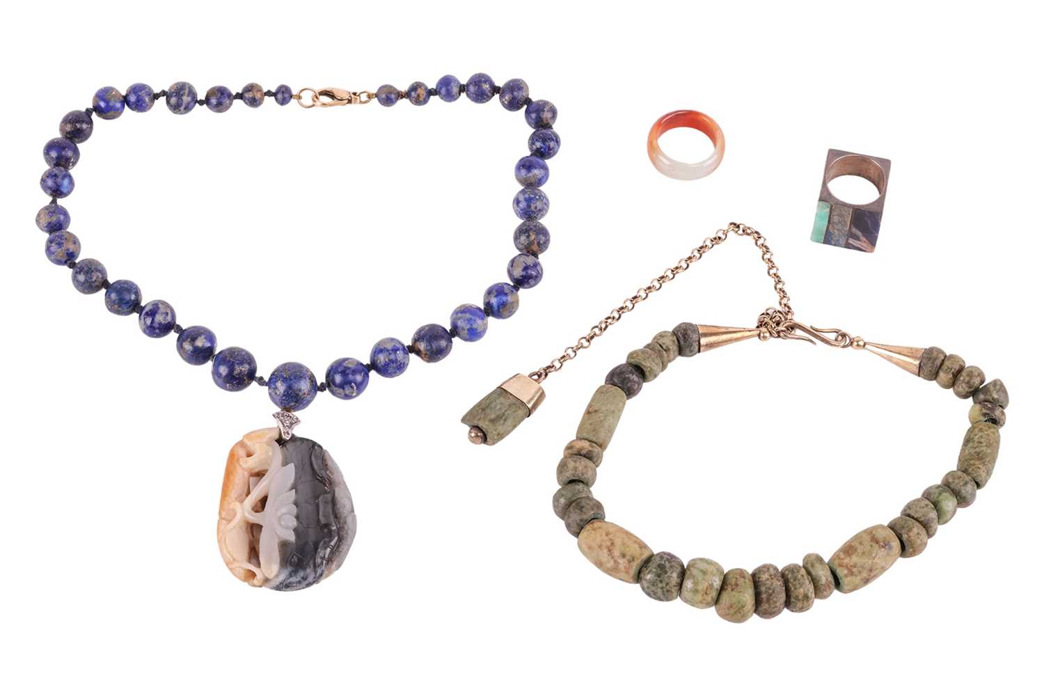 Lot 35 - A Chinese carved nephrite pendant on a lapis...