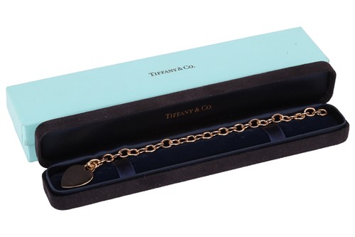 Lot 37 - Tiffany & Co. - a heart charm bracelet; of...