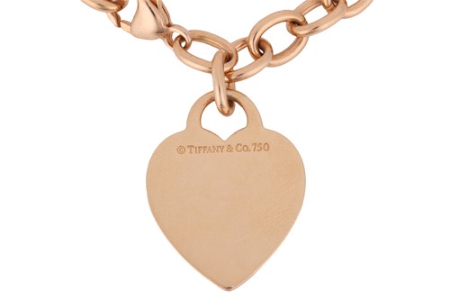 Lot 37 - Tiffany & Co. - a heart charm bracelet; of...