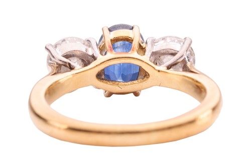 Lot 100 - A sapphire and diamond three-stone ring,...