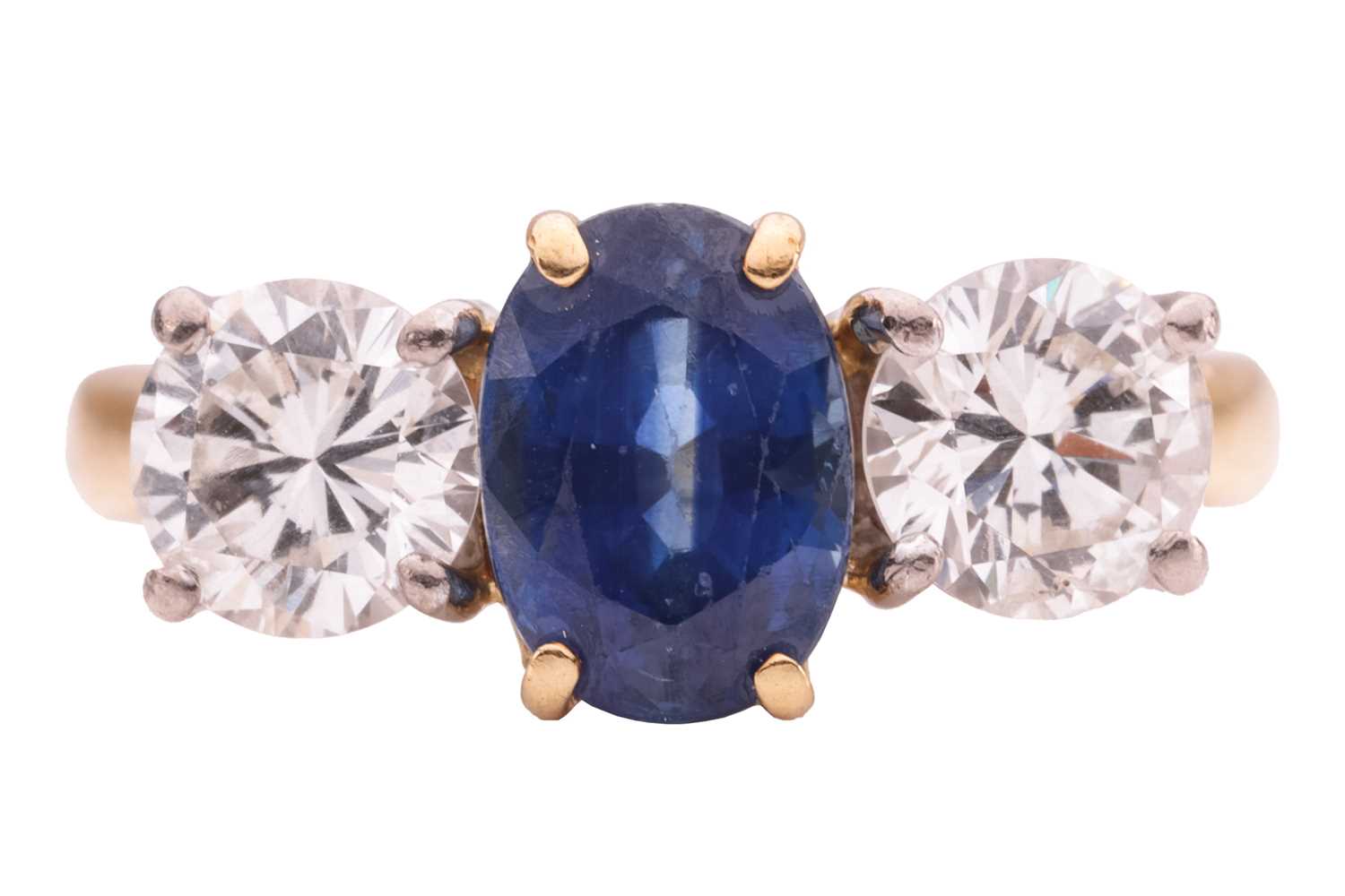 Lot 100 - A sapphire and diamond three-stone ring,...