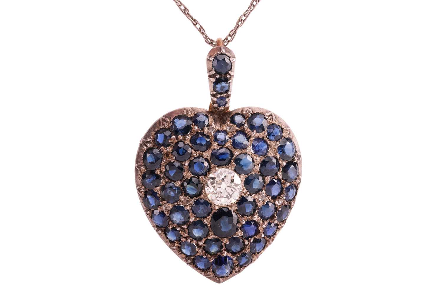 Lot 100 - A sapphire and diamond heart-shaped locket on...