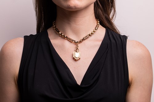 Lot 11 - A Late Victorian locket on chain, comprising a...