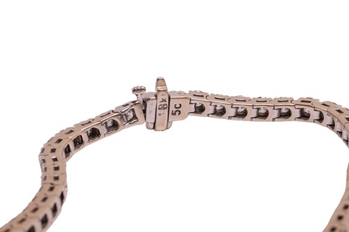 Lot 52 - A diamond line bracelet, with an estimated...