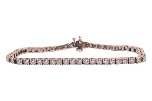 Lot 52 - A diamond line bracelet, with an estimated...