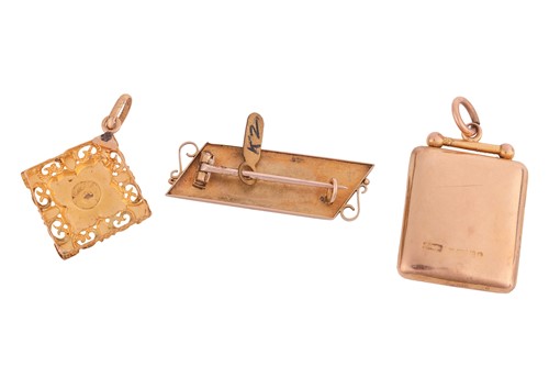 Lot 29 - A locket, a pendant and a brooch; the polished...
