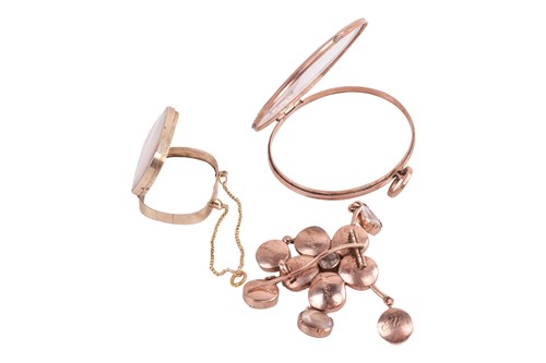 Lot 136 - A floral mourning brooch and two glass lockets;...
