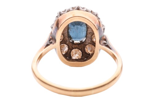 Lot 28 - A sapphire and diamond cluster ring, centred...