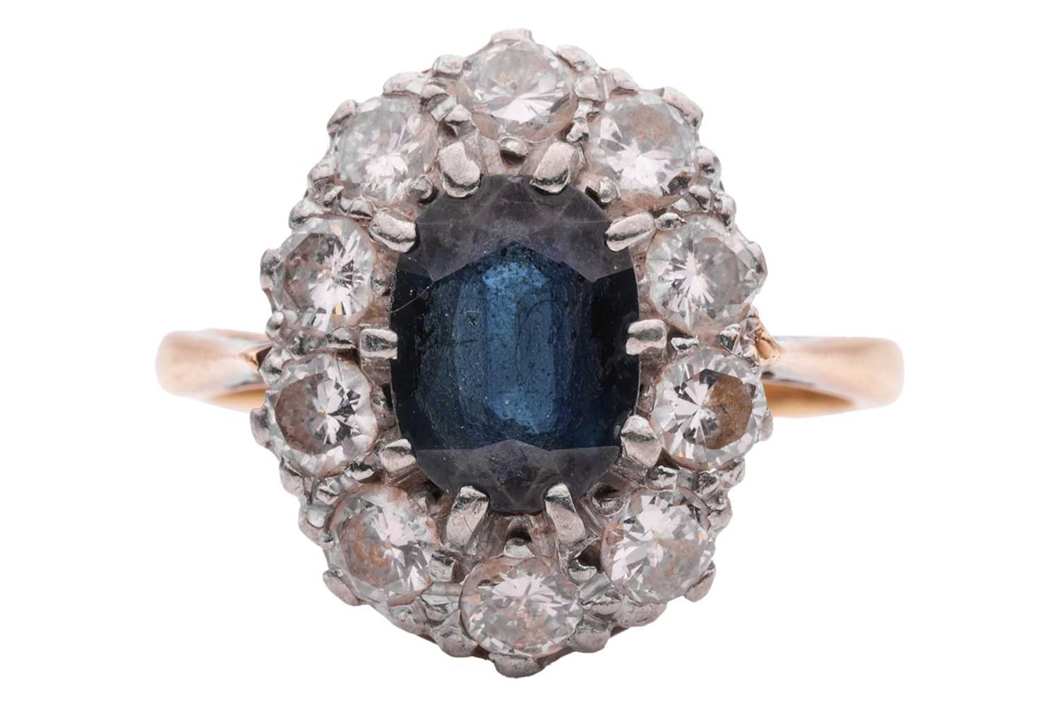 Lot 28 - A sapphire and diamond cluster ring, centred...