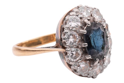 Lot 28 - A sapphire and diamond cluster ring, centred...