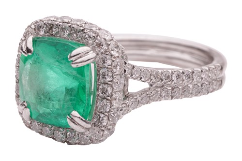 Lot 12 - An emerald and diamond cluster ring in...