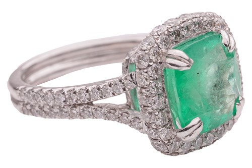 Lot 12 - An emerald and diamond cluster ring in...