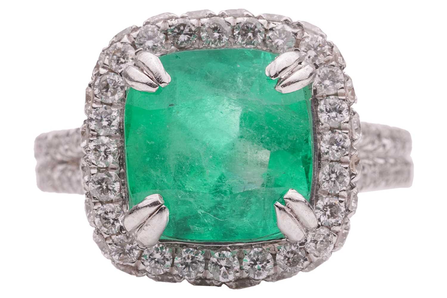 Lot 12 - An emerald and diamond cluster ring in...