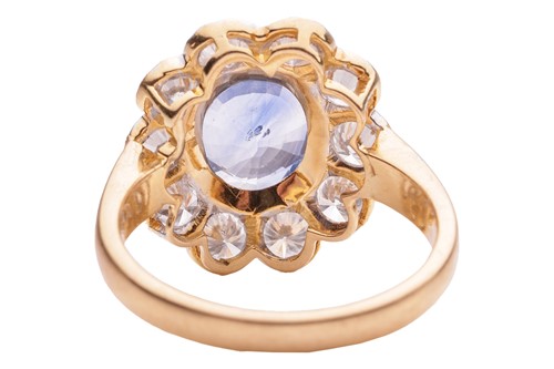 Lot 75 - A sapphire and diamond cluster ring in 18ct...