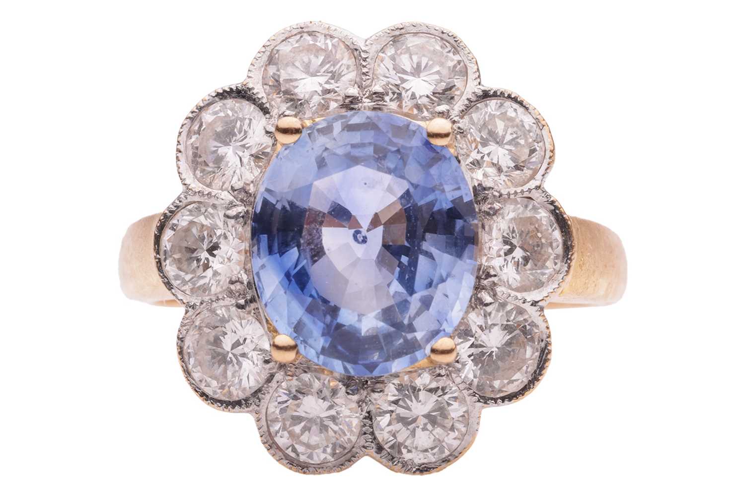 Lot 75 - A sapphire and diamond cluster ring in 18ct...