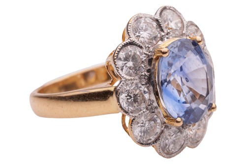 Lot 75 - A sapphire and diamond cluster ring in 18ct...